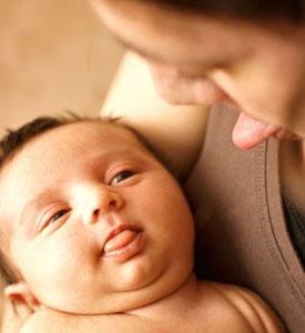 a woman and a baby stick out there tongues